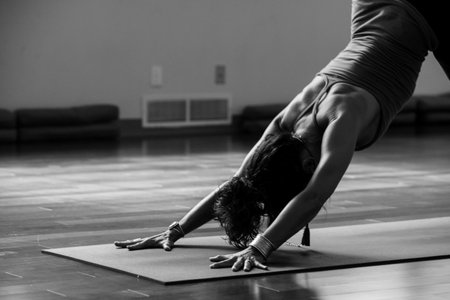 Young woman practicing yoga in the studio. Black and white photo.の写真素材