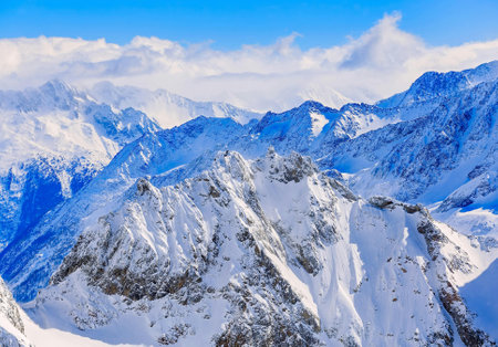 Mountain landscape with snow and clear blue sky.