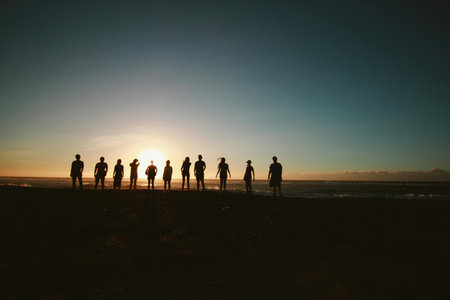 Silhouette of a group of people at sunset on the beach