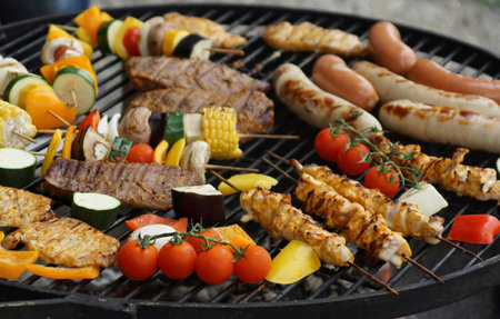 Barbecue with grilled meat, vegetables and mushrooms on grill, closeupの写真素材