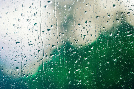Rain drops on the glass. Raindrops on the window. Abstract background.の写真素材