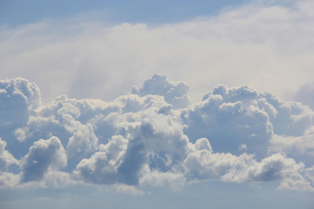 The vast blue sky and clouds form a beautiful sky background.の写真素材