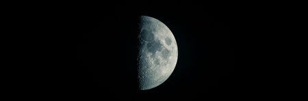 Half moon on black background. Close-up view of the moon.の写真素材