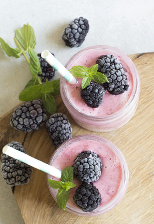 Smoothies with blackberry, blackberry and mint in glass jars