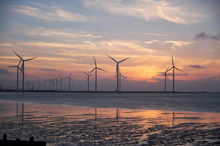 Wind turbines on the beach at sunset, wind farm in Thailand.