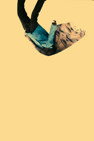 Low angle view of man in blue jeans and t-shirt against yellow background
