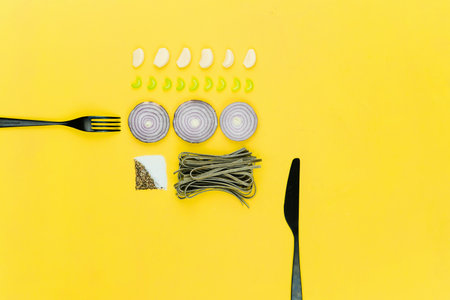Ingredients for cooking pasta on yellow background, top view, flat layの写真素材