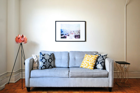 interior of modern living room with grey sofa and picture on wall