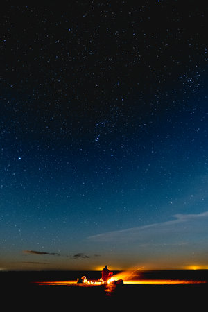 Night starry sky with a person in the foreground. Long exposure photograph