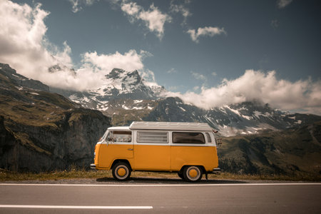 Vintage campervan on the road in the swiss alps