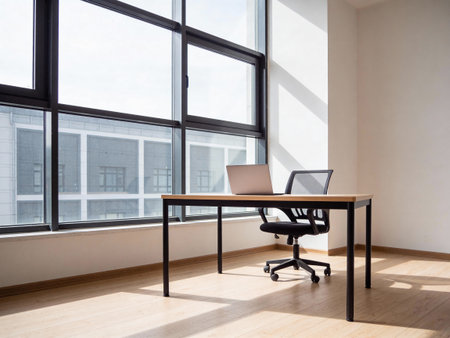 Laptop on a desk in a modern office with panoramic windows
