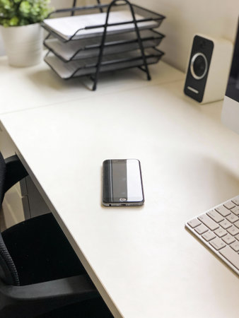 Office desk with smart phone and computer on white table, stock photo