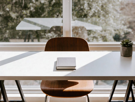 Close up of a desk with a book on it and a chairの写真素材