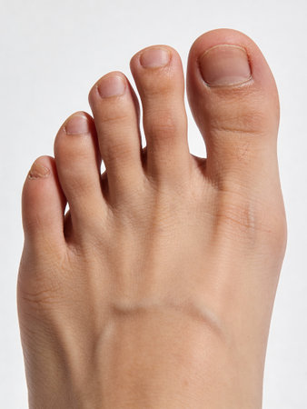 Female foot on a white background, close-up, studio shotの写真素材