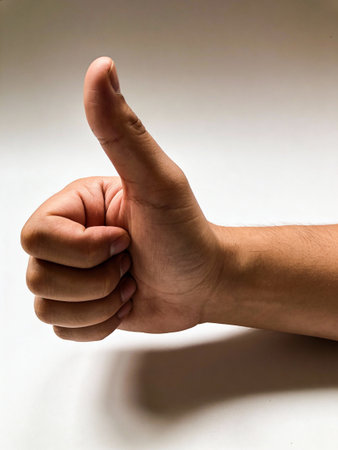thumb up on a white background, close up of a handの写真素材