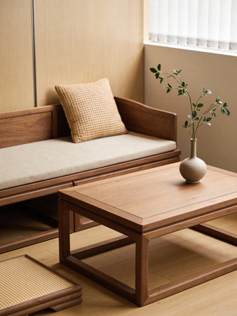 Wooden sofa with pillows and a vase on the table