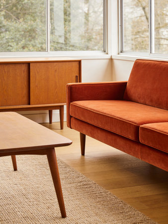 Interior of a living room with a brown sofa and wooden table