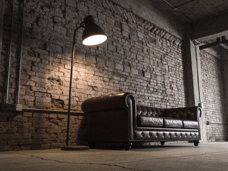Luxury leather sofa and floor lamp in dark room with brick wallの写真素材