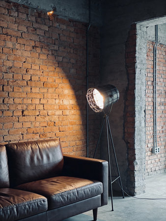 interior of loft living room with brown leather sofa and brick wallの写真素材