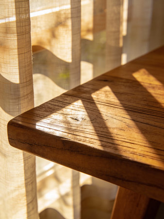 Wooden table and chair in the living room with sunlight and shadow