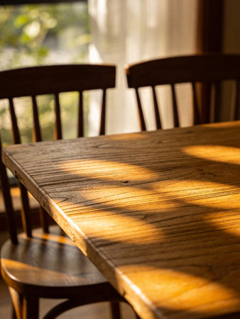 Wooden table and chairs with sunlight in the morning.