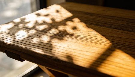 Wooden table with shadow on the window. Selective focus.