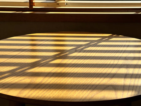 Wooden table with shadow on the window. Sunlight from window.