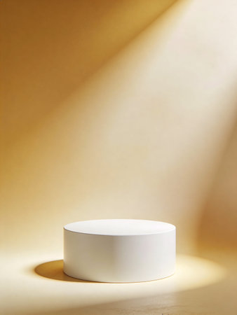 White round podium on a beige background with a spot of lightの写真素材