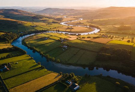Aerial view of the river and fields in the countryside at sunsetの写真素材