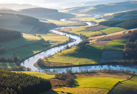 Aerial view of a river flowing through the hills in the countrysideの写真素材