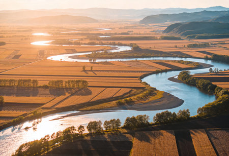 Aerial view of the river and agricultural fields at sunset in Chinaの写真素材