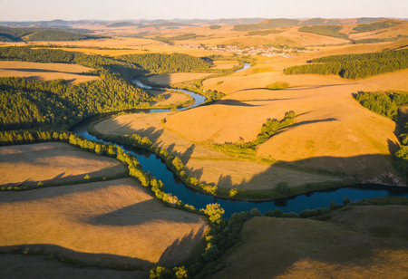 Aerial view of the small river in the middle of the field.の写真素材