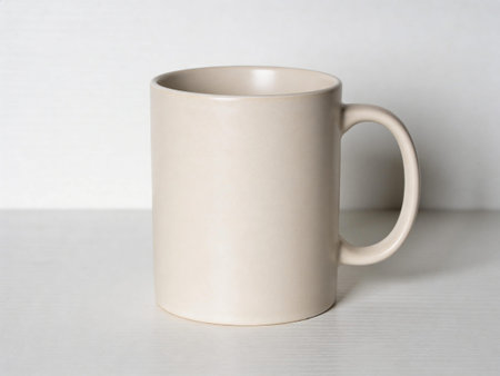 White mug on a white table. White background. Close up.