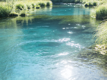 Turquoise water in the mountain river, blue water in the forestの写真素材