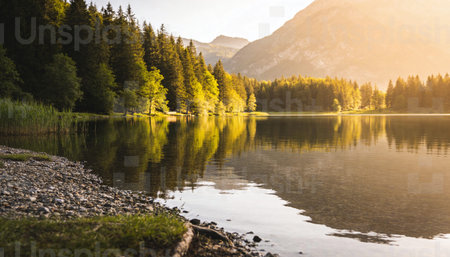 Sunset over the lake in the Austrian Alps. The concept of active and ecological tourismの写真素材