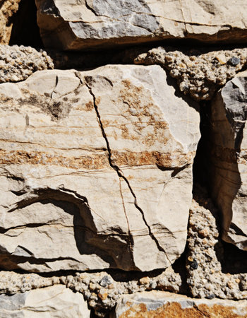Texture, background. The surface of the stone is covered with cracks