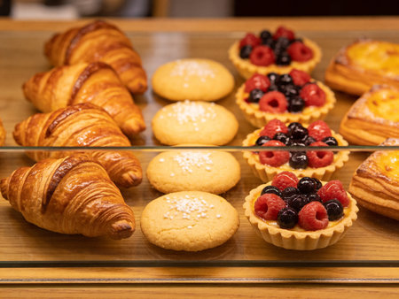 assortment of berry pastries in bakery shop, closeup