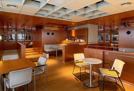 Interior of a restaurant with wooden tables and chairs. Nobody inside