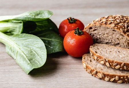 Healthy breakfast with bread, tomatoes, spinach and sunflower seeds