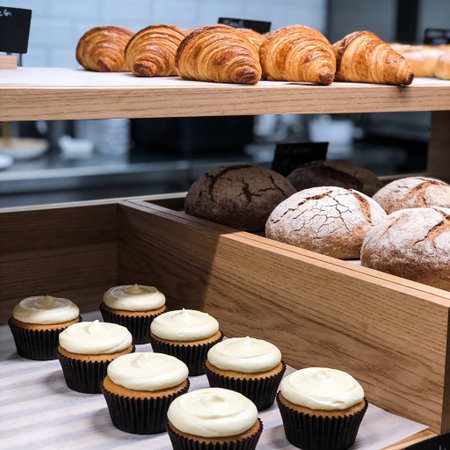 Freshly baked buns and muffins on display in a bakery