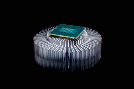 Computer processor chip CPU with aluminum cooler on black reflective backgroundの写真素材