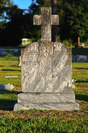 Headstone with stone cross intended for a parental burial plot