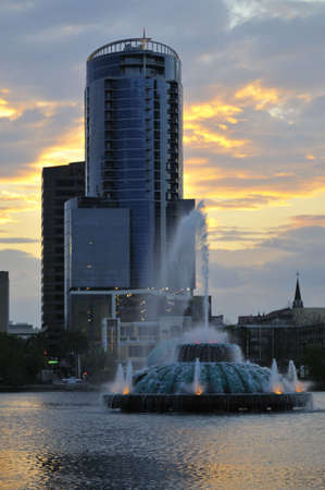 Lake Eola Fountain in downtown Orlando, FL with high-rise building in distanceの写真素材