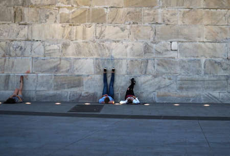 Washington, DC USA. Aug 2008. Young couple lying on their backs looking and taking pictures from...