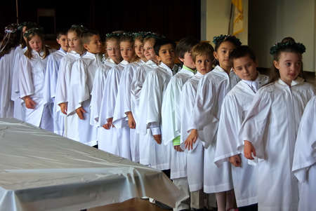 Middletown, CT USA. May 2009. Young Catholic children in white gowns waiting in line to receive...