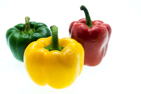Three sweet peppers in red, yellow and green color