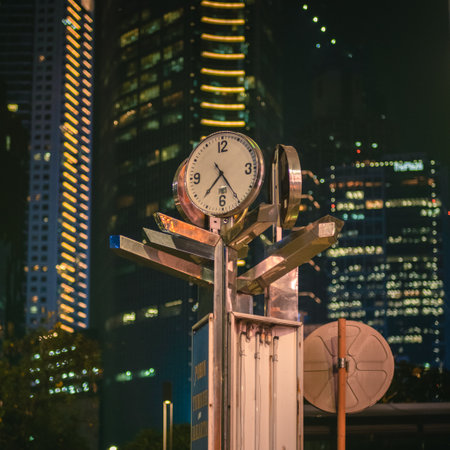 The clock is on the street in Hong Kong at night time.の写真素材