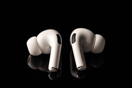 Kuala Lumpur, Malaysia - December 2019. Apple Airpods Pro isolated against black. The new airpods pro features active noise cancelling and  customizable fitのeditorial素材