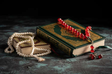 Islamic concept for eid and ramadan: The holy qoran with tasbih (rosary beads)の写真素材