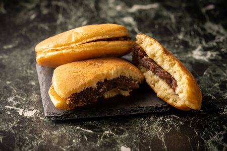 Dorayaki is a type of Japanese confection, a red-bean pancake which consists of two small pancake-like patties made from castella wrapped around red bean paste.の写真素材